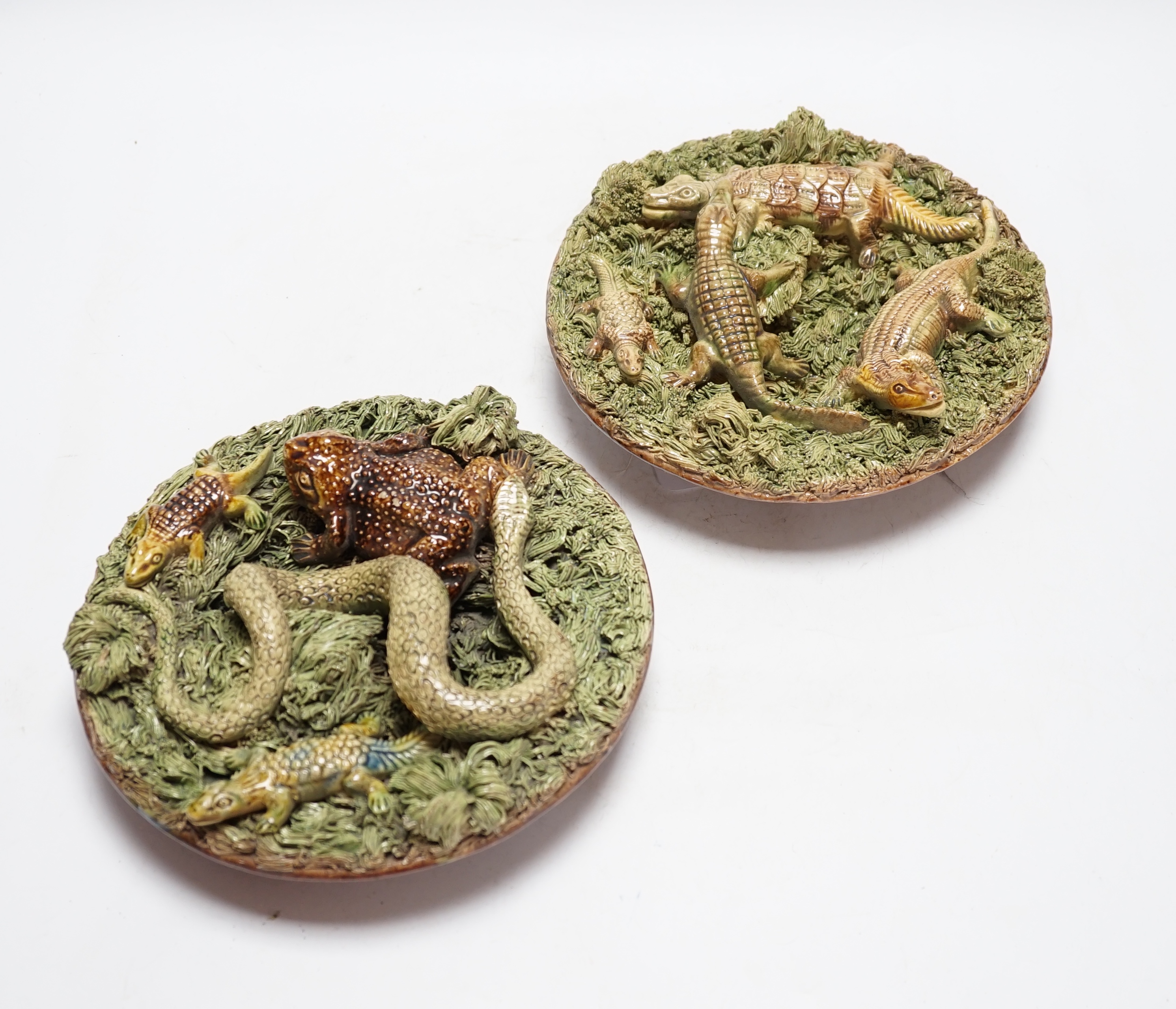 Two Caldas Palissy ware dishes decorated with crocodiles, a frog and a snake, the larger 21cm diameter